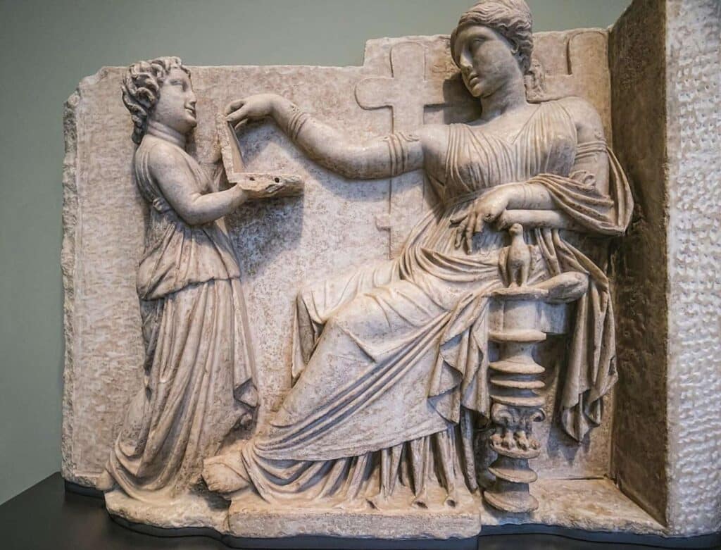 Gravestone of a Greek high status woman master being taken care of by her slave attendant.