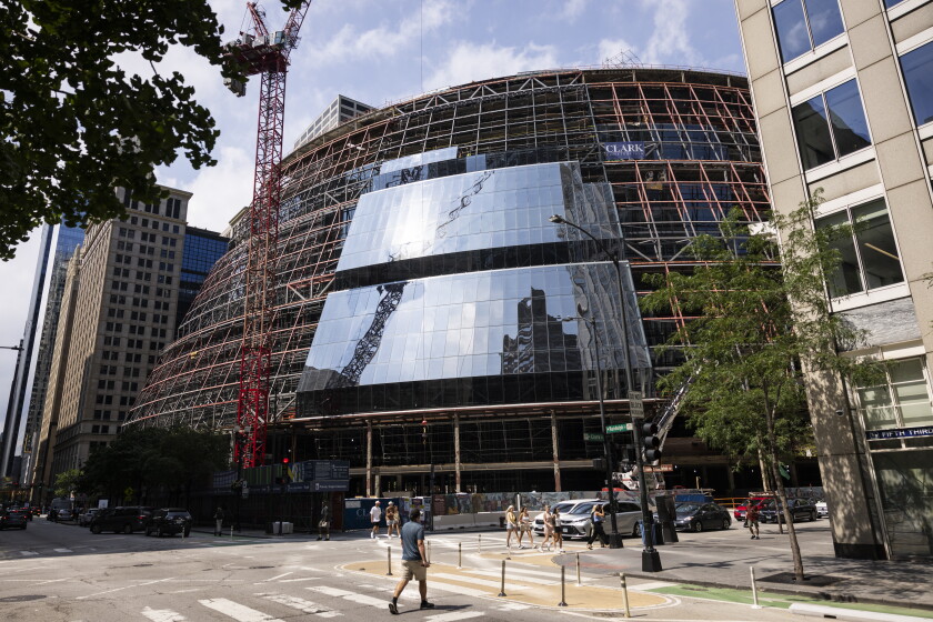 Workers install new exterior glass at the Thompson Center in the Loop on Aug. 22, 2025.