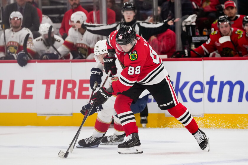 Patrick Kane battles Anton Lundell for the puck during the second period Sunday at the United Center.