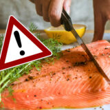 Eine person schneidet mit einem messer ein fischfilet auf einer arbeitsplatte