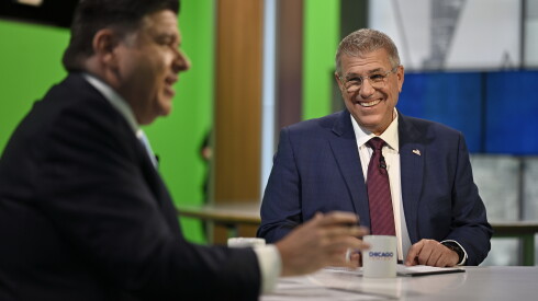 Gov. Jb pritzker doling out big bucks to help democrats — and boost a 2028 presidential run 2026 - justice Republican challenger darren bailey listens as democratic gov. Jb pritzker, foreground, speaks prior to the live broadcast of the wttw news gubernatorial forum on tuesday, oct. 13, 2026, at the renée crown public media center in chicago.