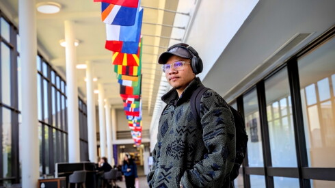 Lui Rodriguez at Joliet Junior College, where flags from many countries are displayed.