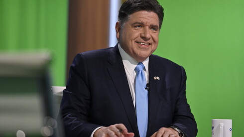 Democratic Gov. JB Pritzker smiles from the anchor table before the live broadcast of the WTTW News Gubernatorial Forum at WTTW’s North Side studios on Tuesday, Oct. 13, 2026, in Chicago.