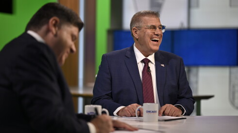 Republican nominee Darren Bailey laughs beside Democratic Gov. JB Pritzker before the start of the televised WTTW News Gubernatorial Forum on Tuesday, Oct. 13, 2026, at WTTW studios on the North Side of Chicago.