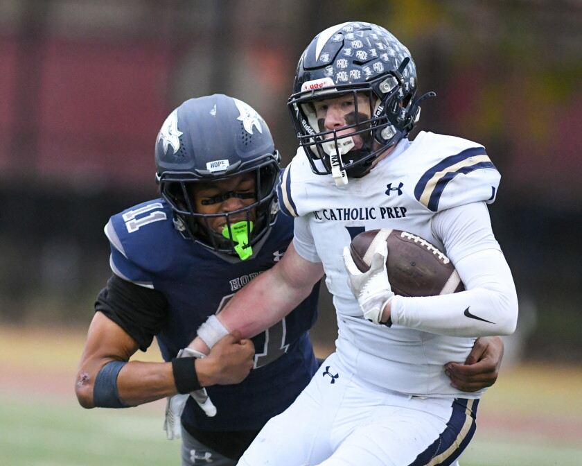 Hope Academy’s Devin Mims (11) tries to tackle IC Catholic Prep's Will Schmidt (1) during Class 3A state playoffs last season.
